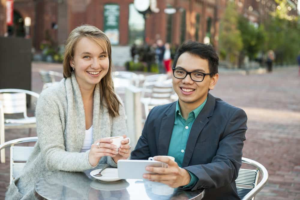 Young people with mobile phone in cafe