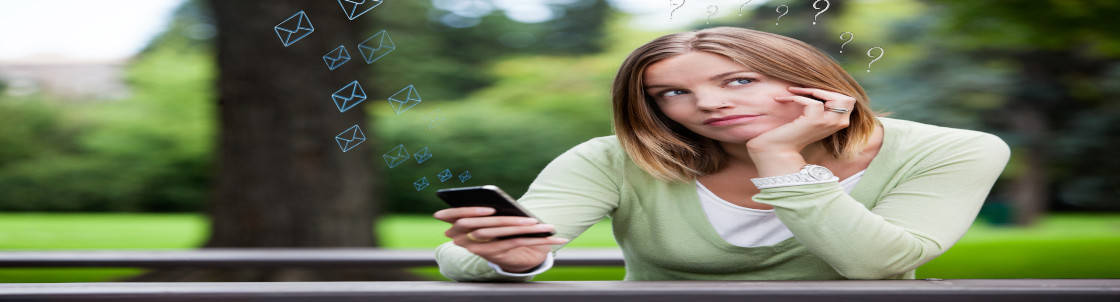 Woman thinking holding a phone